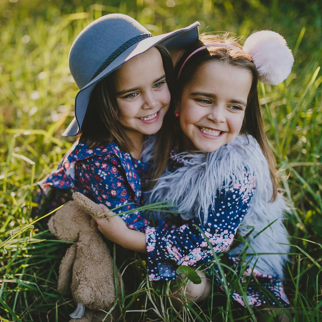Photo taken by Central Coast photographer Kendell Tyne of two young girls hugging.