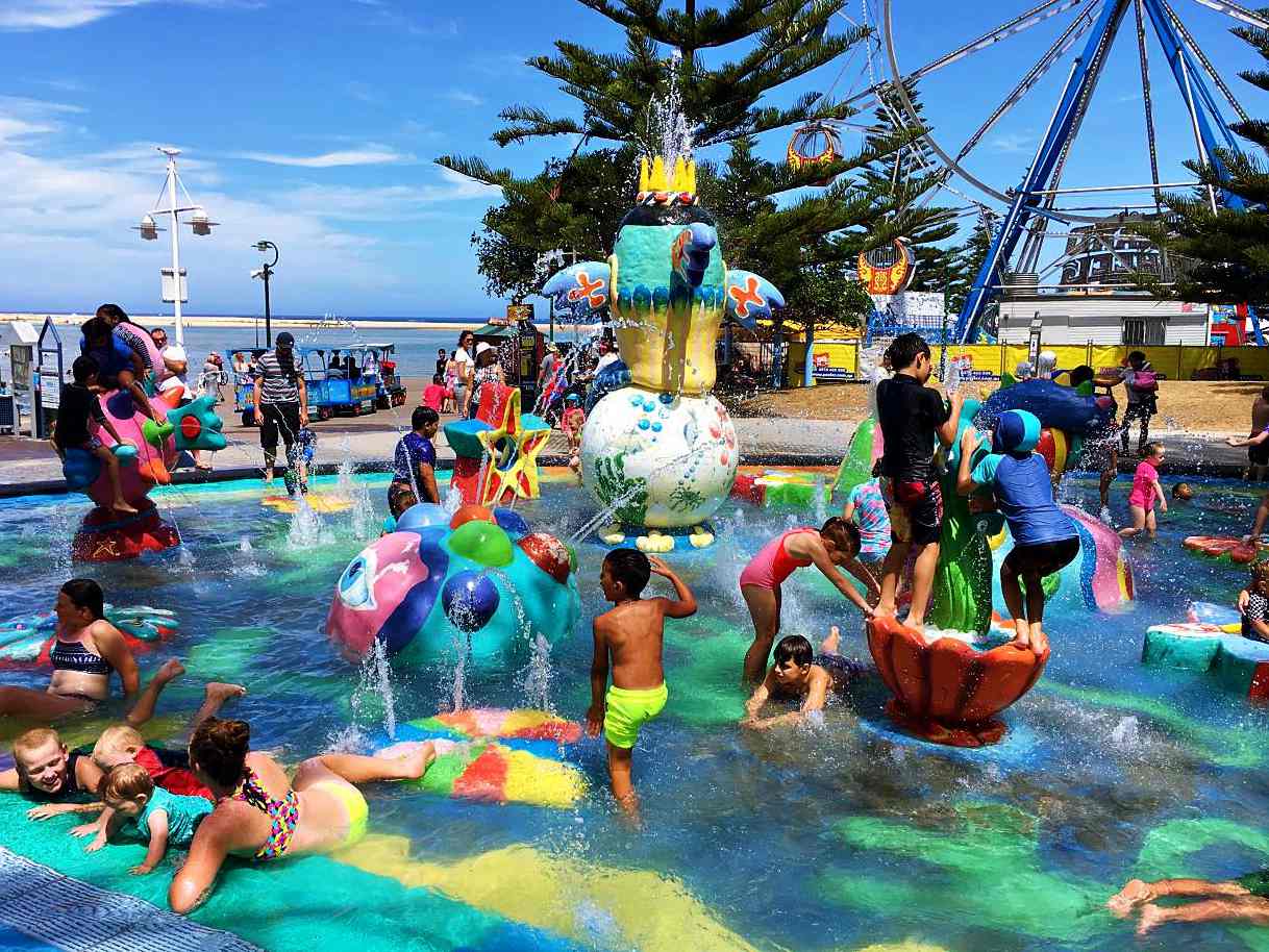 Kids splashing in the water amongst the colourful sculptures of Vera's Water Garden in The Entrance.