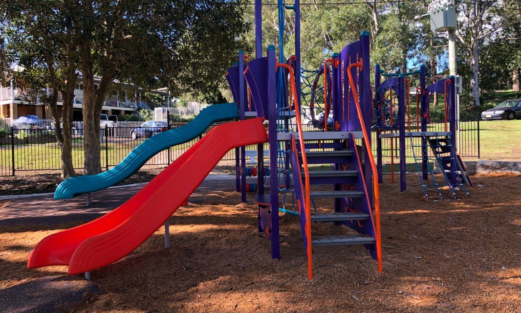 The Brightly Coloured Play Equipment at Goonak Parade Playground in Narara is Shaded by Mature Gums